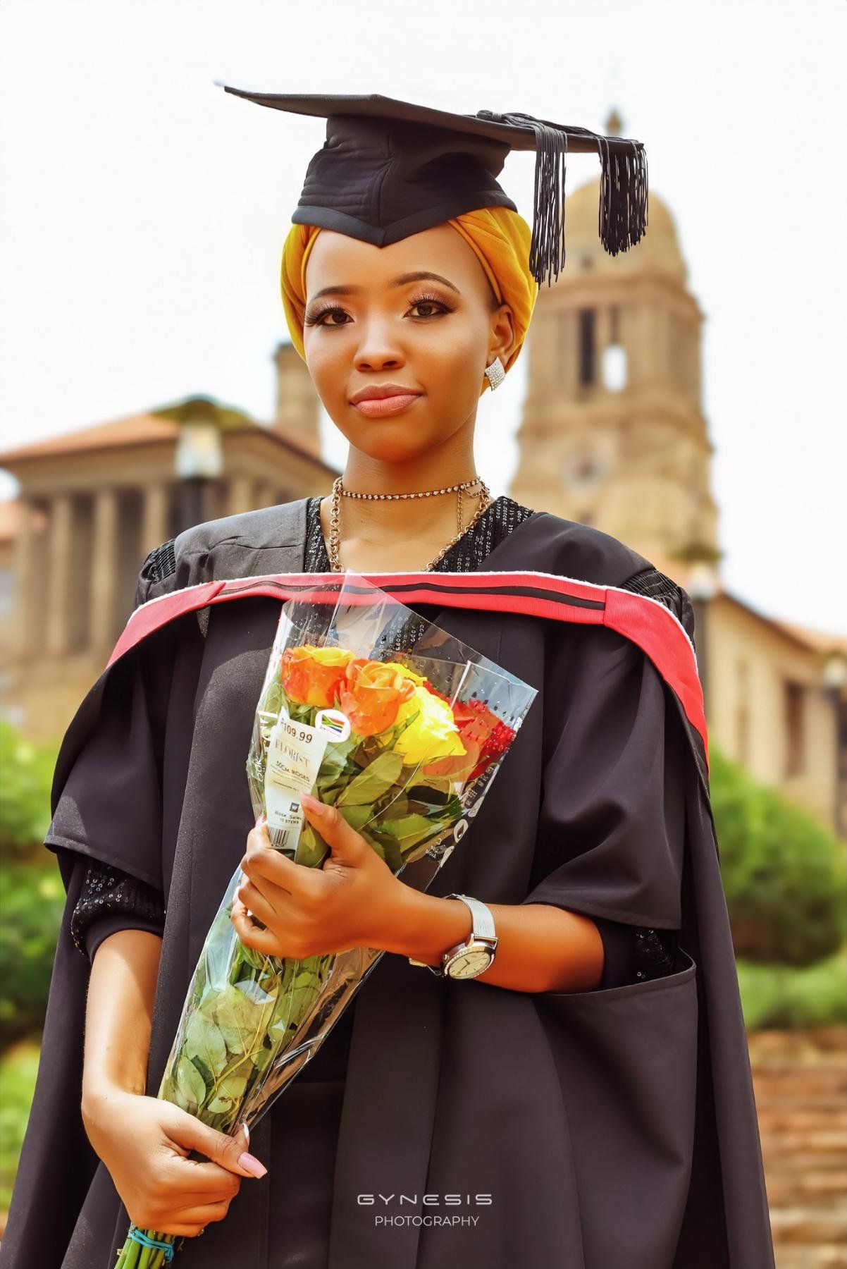 Graduation photoshoot in Pretoria, Pretoria North, Pretoria West, Gauteng, South Africa with a model dressed in graduation attire holding a bouquet of flowers.