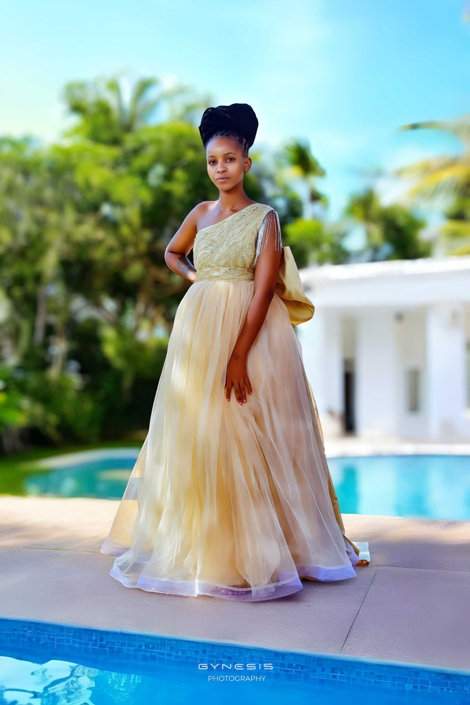 Matric dance photoshoot in Pretoria, Pretoria West, Pretoria North, Gauteng, South Africa featuring a model in a flowing gold gown by a swimming pool.