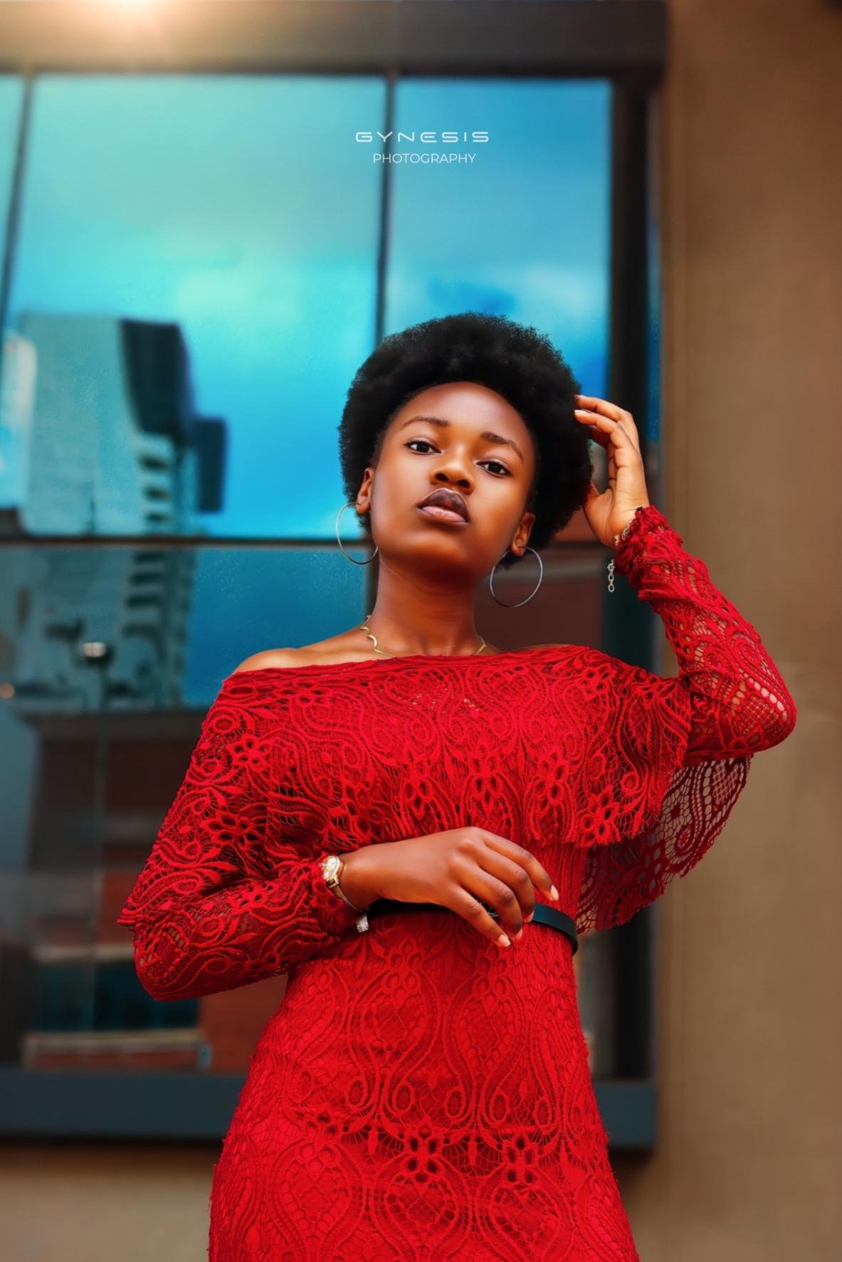 Lifestyle birthday photoshoot in Pretoria, Pretoria West, Pretoria North, Gauteng, South Africa featuring a model in a stunning red dress against a modern backdrop with huge afro hair.